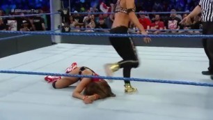 Carmella makes niki bella tap out with headsissors
