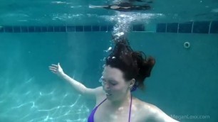 Sexy girl underwater in purple bikini